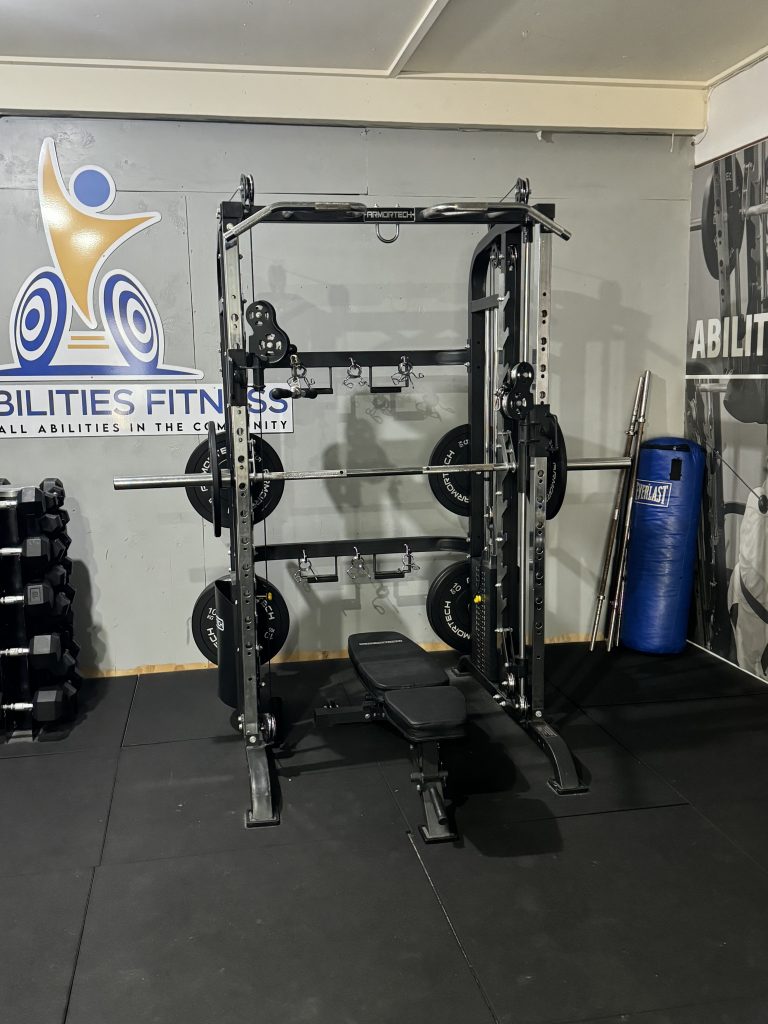 A trainer supporting a member through a workout
